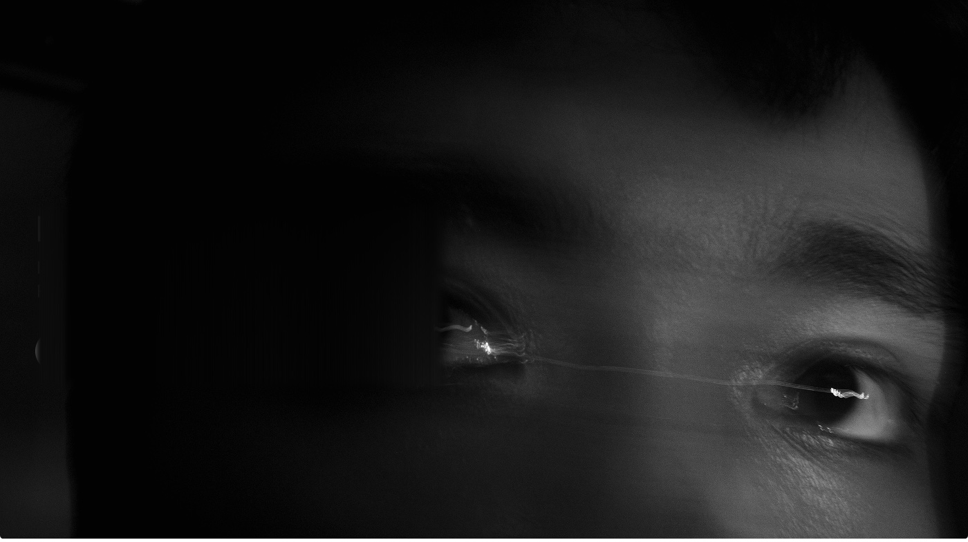 Close monochrome portrait of a person looking toward the light